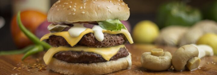 A hamburger with mushroom on the side