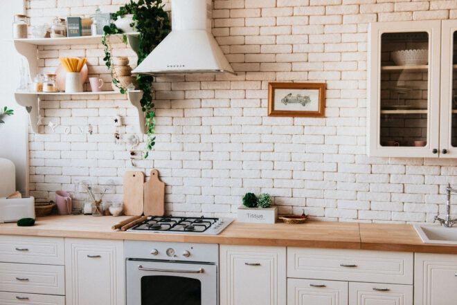 A white brick kitchen with wooden countertops