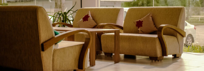 A set of couches with wood armrests