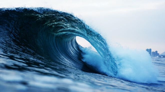 A large wave crashing in the ocean