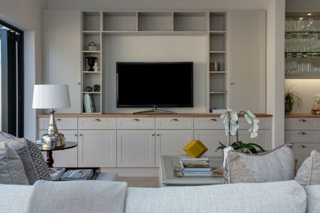 White living room with a center TV console