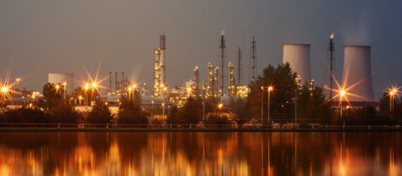 A horizon of a coal plant alongside a river bank