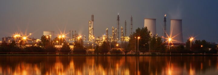A horizon of a coal plant alongside a river bank
