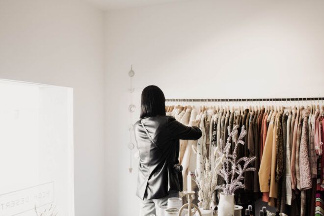 A woman looking at her clothing rack closet