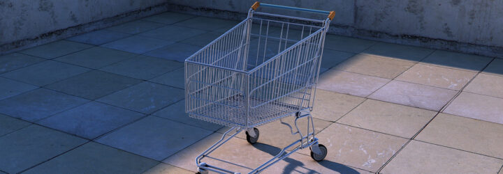 An empty supermarket shopping cart on a concrete ground