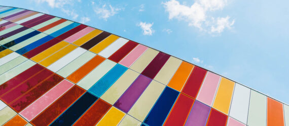 A glass building with colorful panels