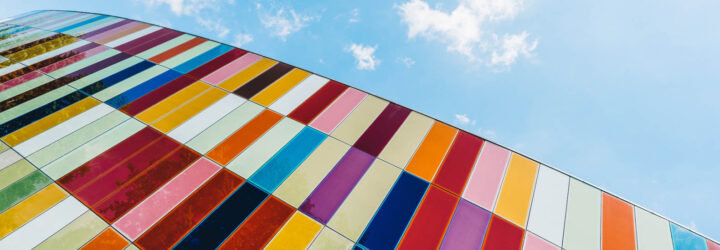 A glass building with colorful panels