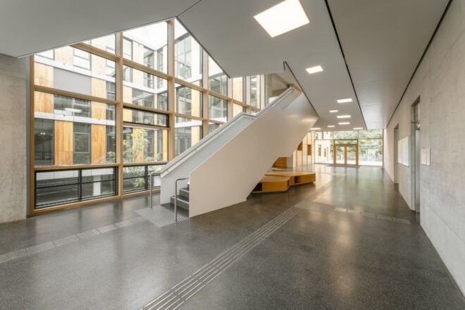 White staircase near large windows