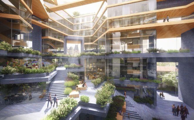 Plants decorate the inside alongside white stairs and glass windows