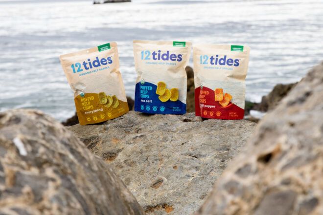 Three chip bags on the beach with ocean in view