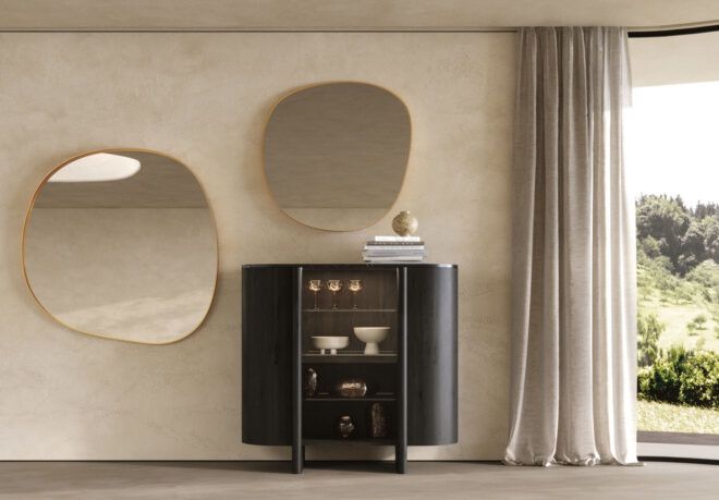 A cabinet with abstract mirrors nearby