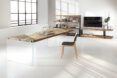 Long table in a white room with a chair