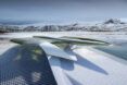 A white landscape with a structure that almost looks hidden in the landscape