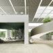Work space surrounded by bookshelves. Ceiling features Hues Topo Green ceiling baffles