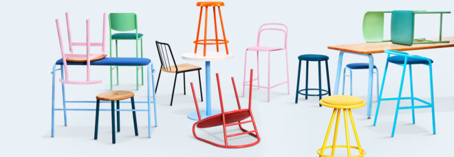 The line of bent-metal chairs in a white backdrop