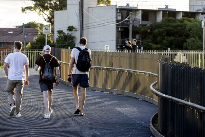 More pedestrians walking along the bridge