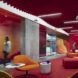 Red and orange themed lounge space with Hues Red ceiling baffles