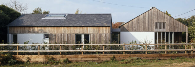View of the home with wood fence