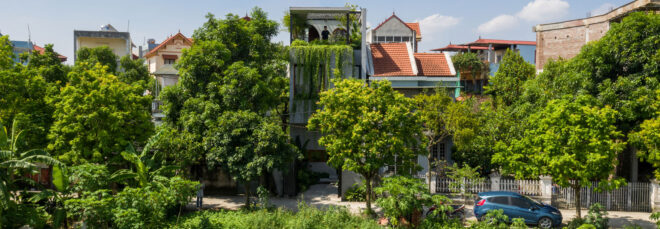 Far away view of the Folding House surrounded by greenery
