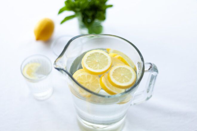 A water pitcher with lemons