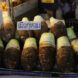 Taro root sold in rows with a sign written in Thai