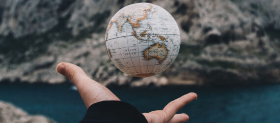 A small globe in someone's hand
