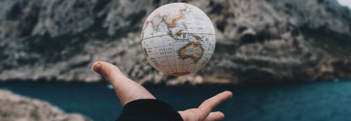 A small globe in someone's hand
