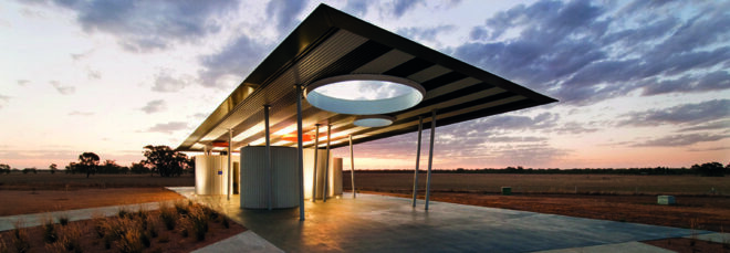 Bus stop at dusk with yellow lights