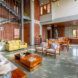 An interior living room space with a staircase along the far wall