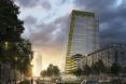 View of the office building and its green facade from the street level at sunset
