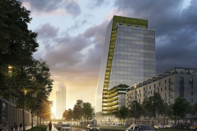 View of the office building and its green facade from the street level at sunset