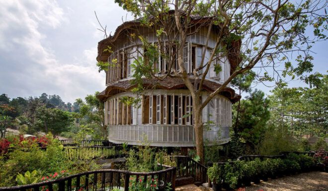 A circular structure with a forest in its background