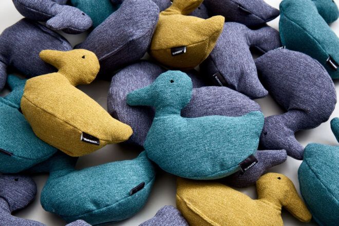 A pile of plush ducks made with the Supreen fabric