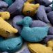 A pile of plush ducks made with the Supreen fabric