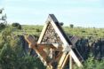 Close up of the top triangular frame of The Octahedron which features a gabion-like mesh filled with rocks