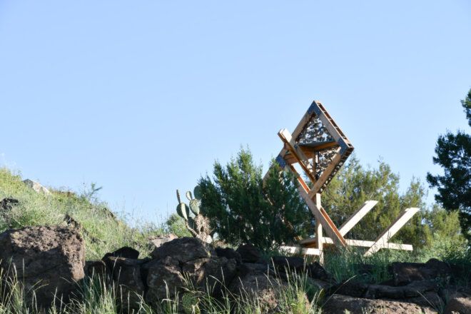 Latticed timber form embedded into lush Arizona desert landscape