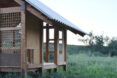 Corner view of the Earth Shed featuring the earth-plastered wall and timber frame
