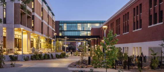 Multiple renovated buildings on the campus at dusk