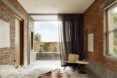 A bedroom with a partition curtain to cover an open doorway