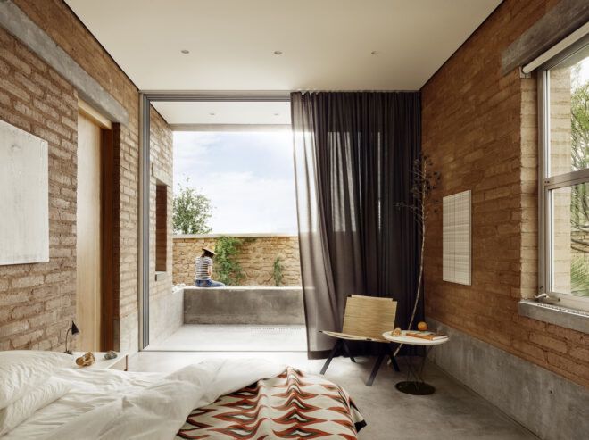 A bedroom with a partition curtain to cover an open doorway
