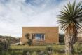A low rectangle building in a desert landscape