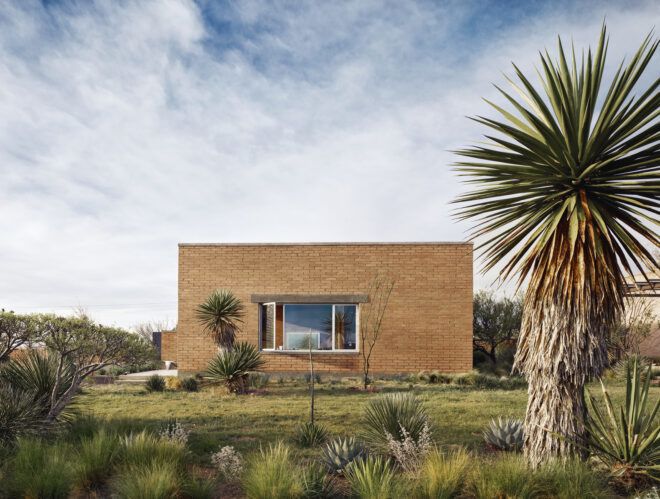 A low rectangle building in a desert landscape