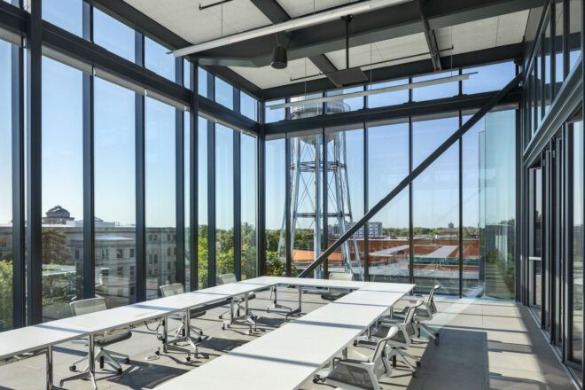 A classroom with full glass windows and bright natural light