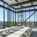 A classroom with full glass windows and bright natural light
