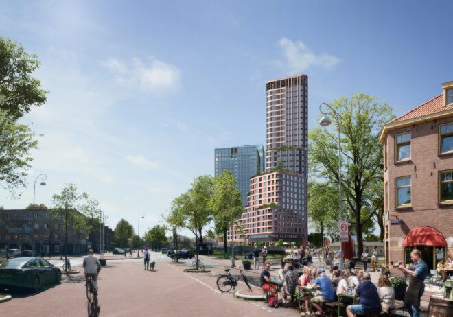 A tall tower in the midst of a street way with people biking
