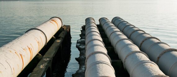 Four sewage pipe leading out to a river