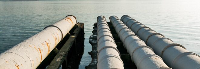 Four sewage pipe leading out to a river
