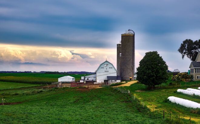 A small farm with a silo