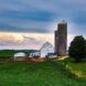 A small farm with a silo