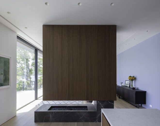 A living room with a blank wooden wall in the center